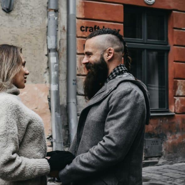 A man and woman facing each other.