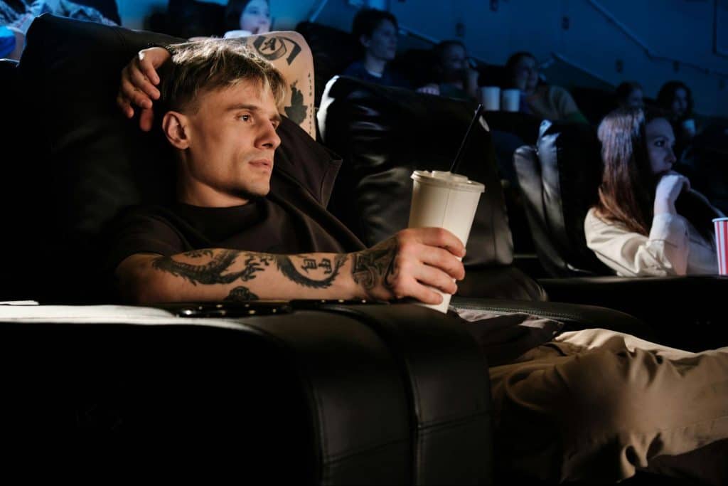 A man watching a movie on his own