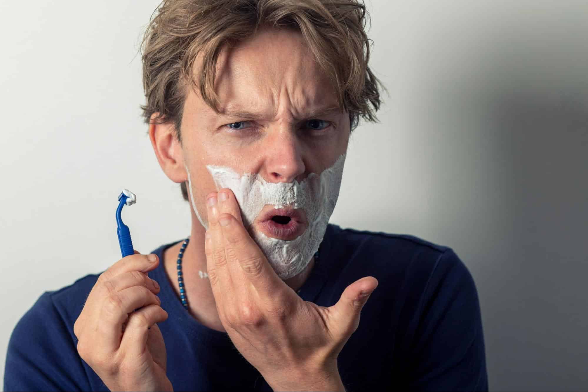 A man using a razor.