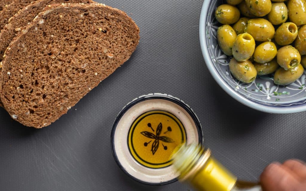 an olive oil and an actual olive.