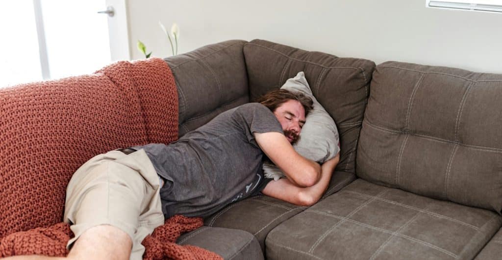 A man sleeping on the couch.