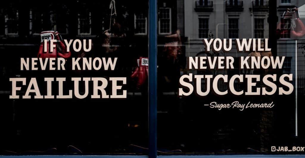 A window sign with an encouraging quote.