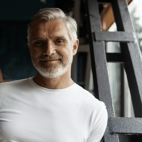 A handsome mature man smiling at the camera
