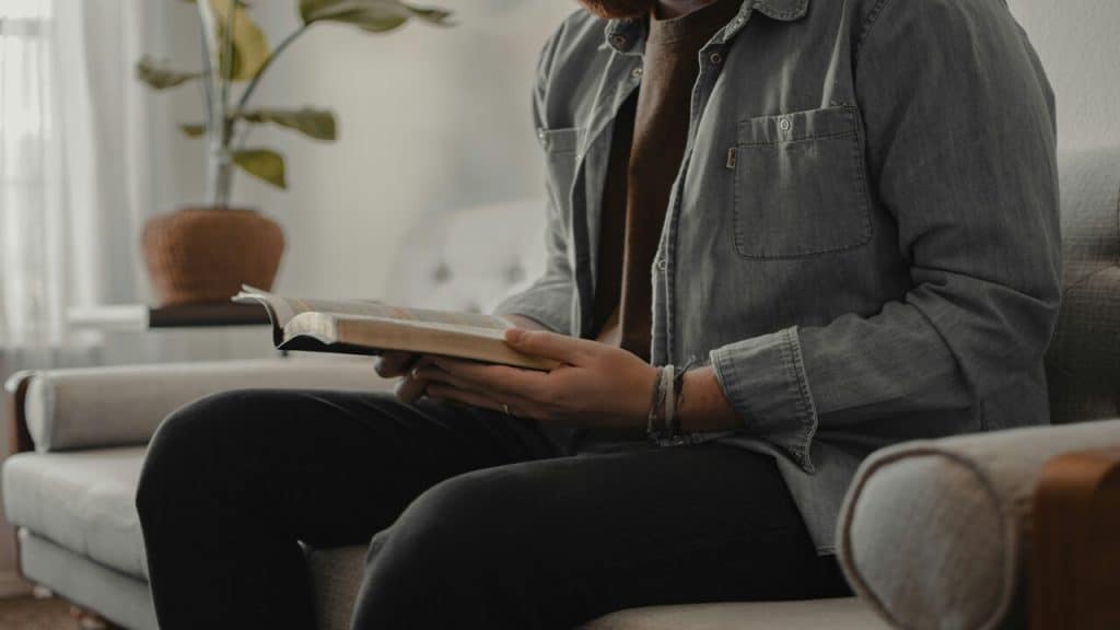 A man reading at home alone.