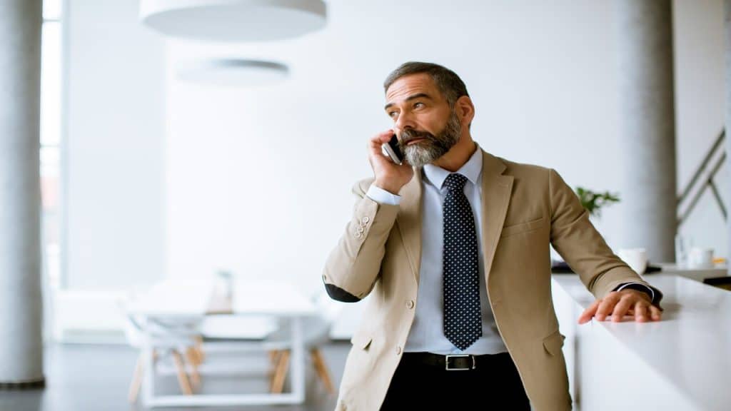 A stylish man on the phone.
