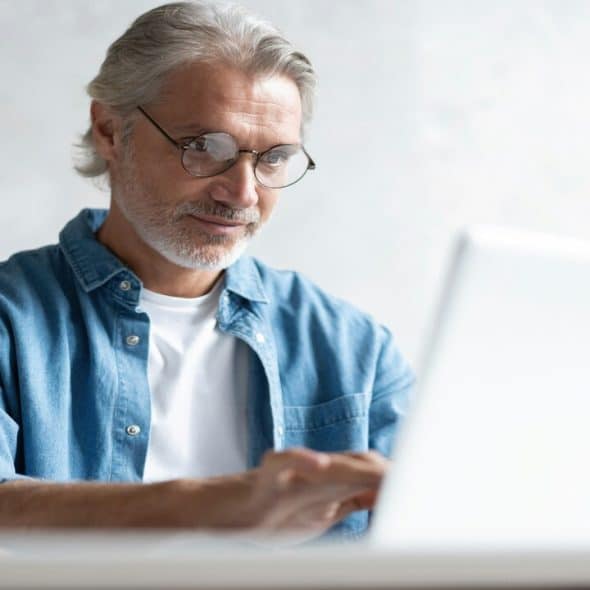 A handsome mature man using his laptop.