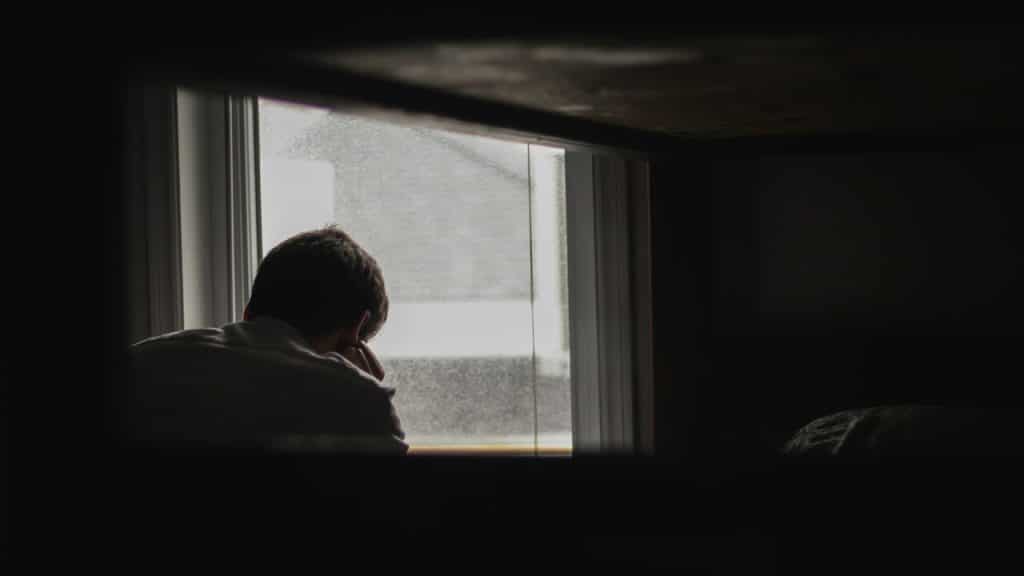 A man looking outside his window.