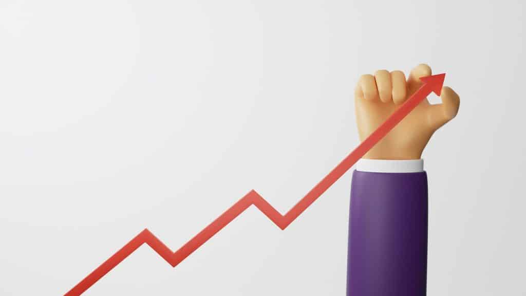 A hand leading a red arrow to growth.