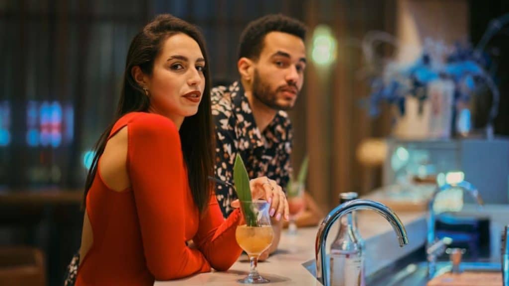 Woman sensing hesitation as partner avoids relationship direction.