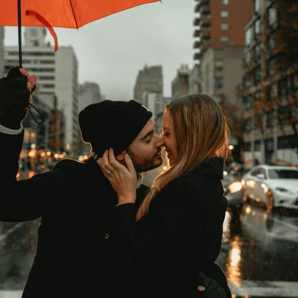 A man and woman under the umbrella.