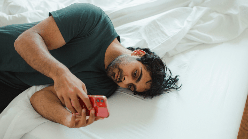 A man looking sadly at his phone