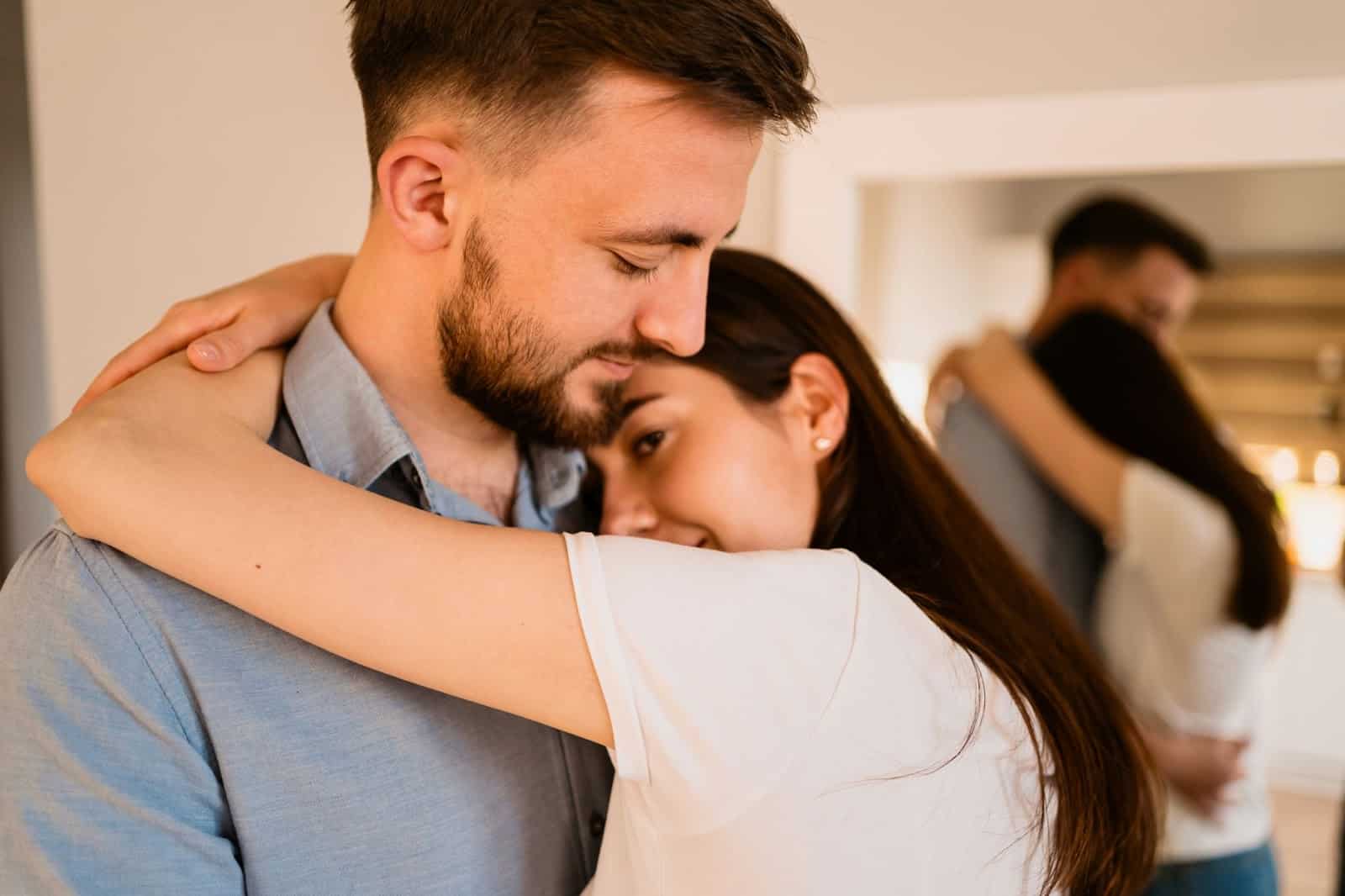 A man and woman hugging each other.