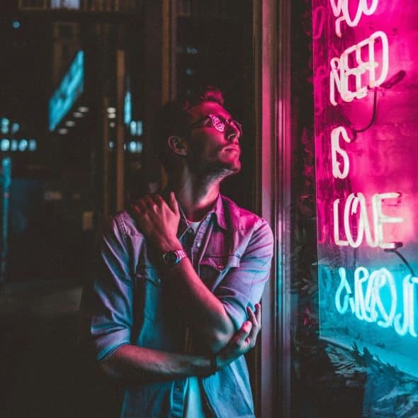 A man standing on a neon lights.