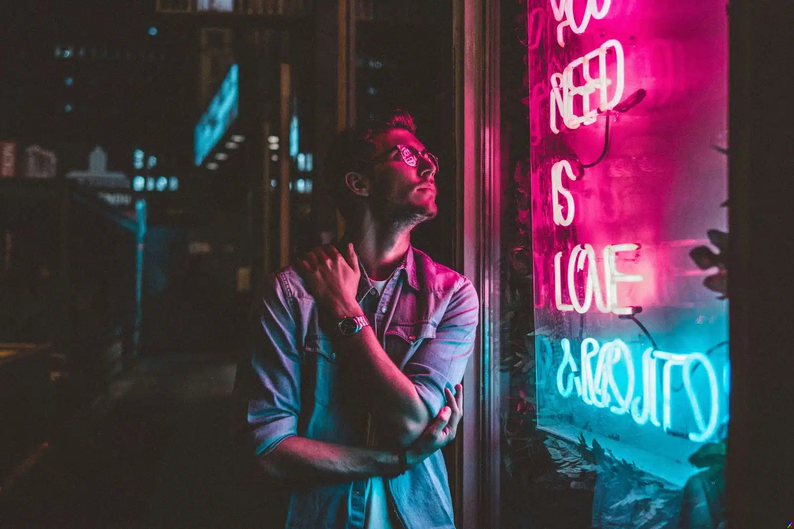 A man standing on a neon lights.