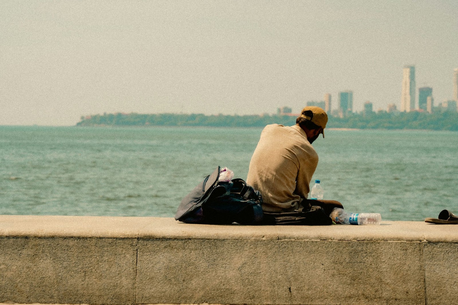 A man sitting alone and looking at the sea