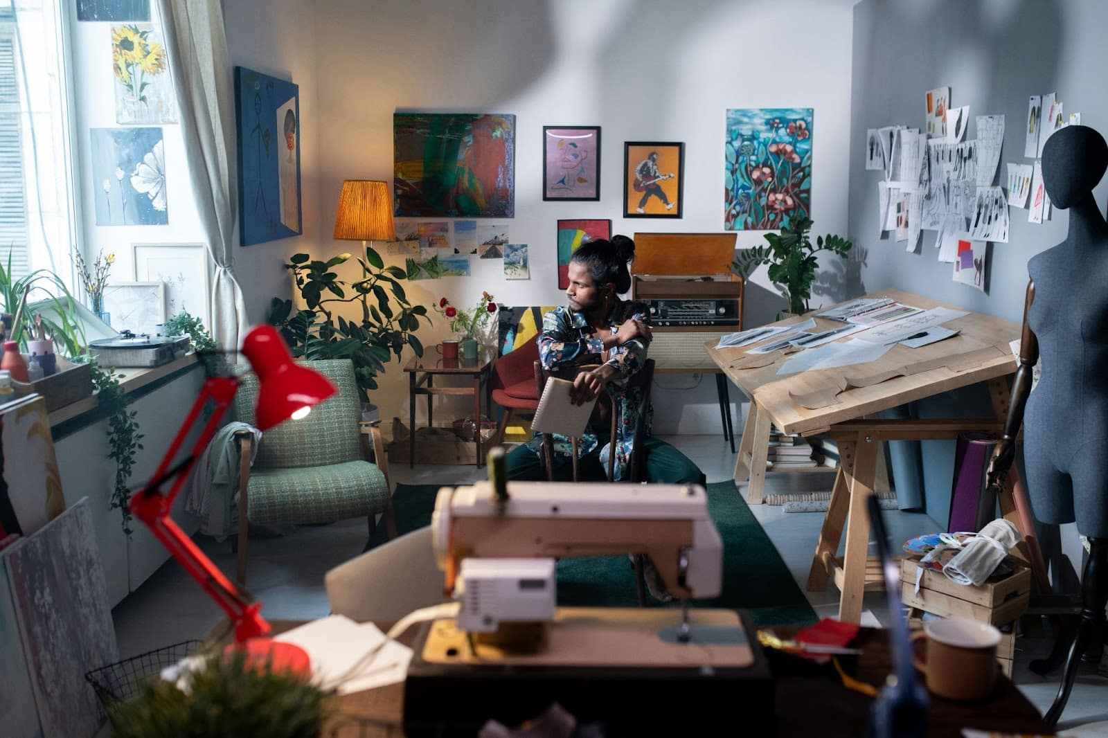 A man sitting surrounded by his art.