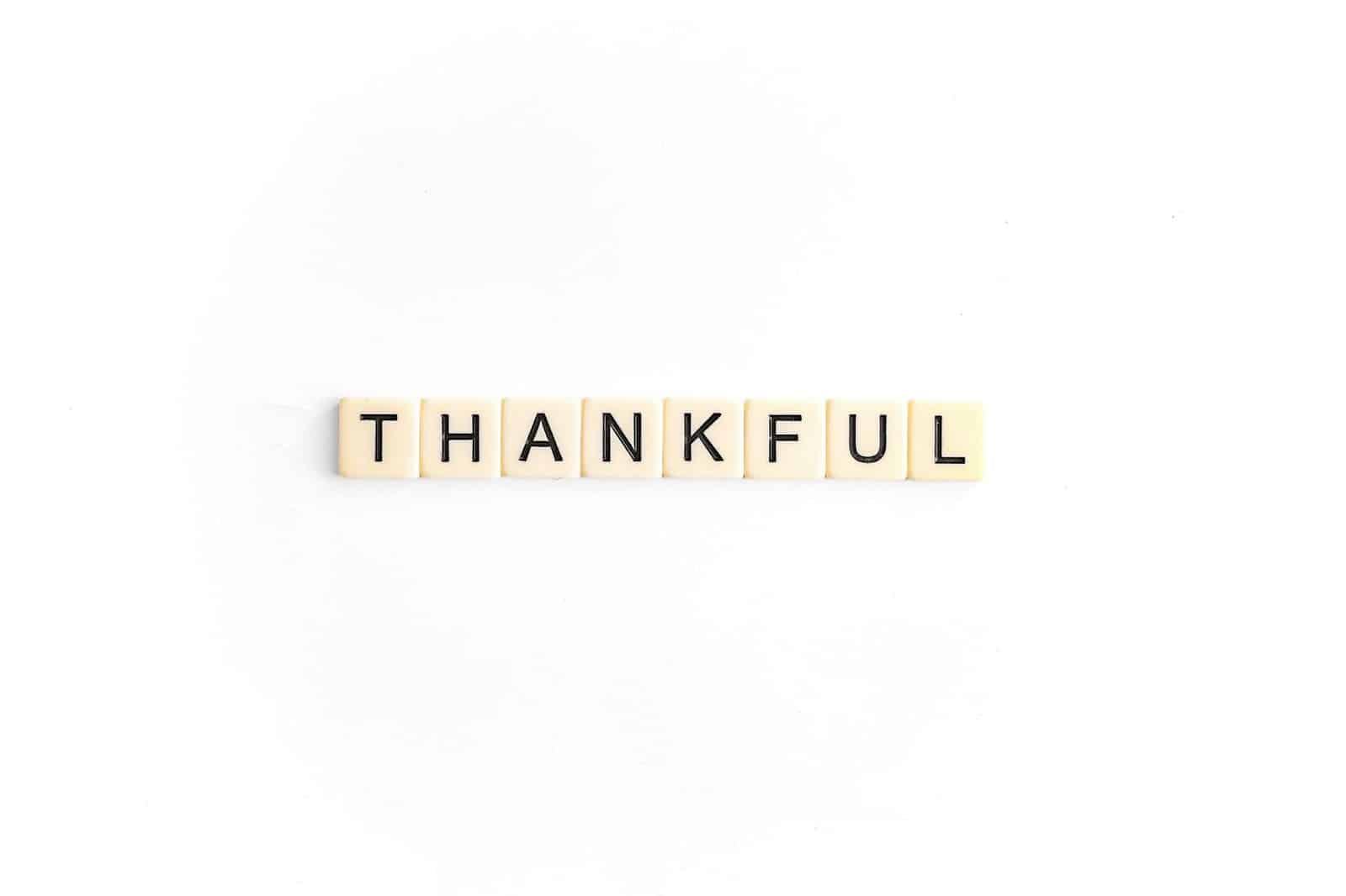 A scrabble letter that says thankful.