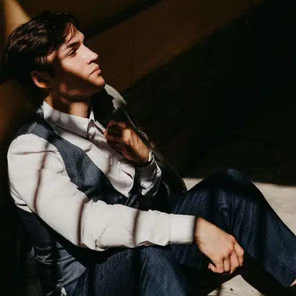 A man leaning on a wall.
