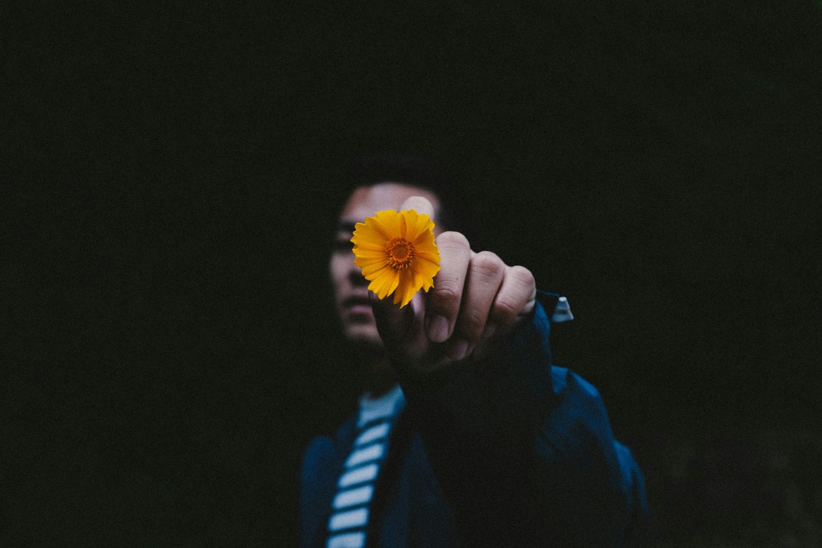 A man holding a flower.