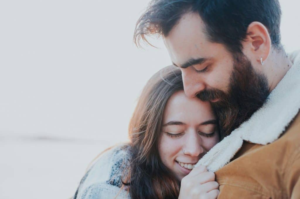 A man embracing a woman