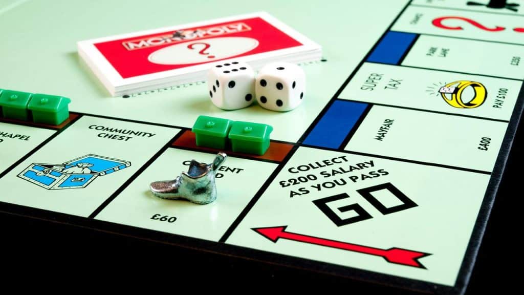 A Monopoly board with dice, houses, and a shoe token.