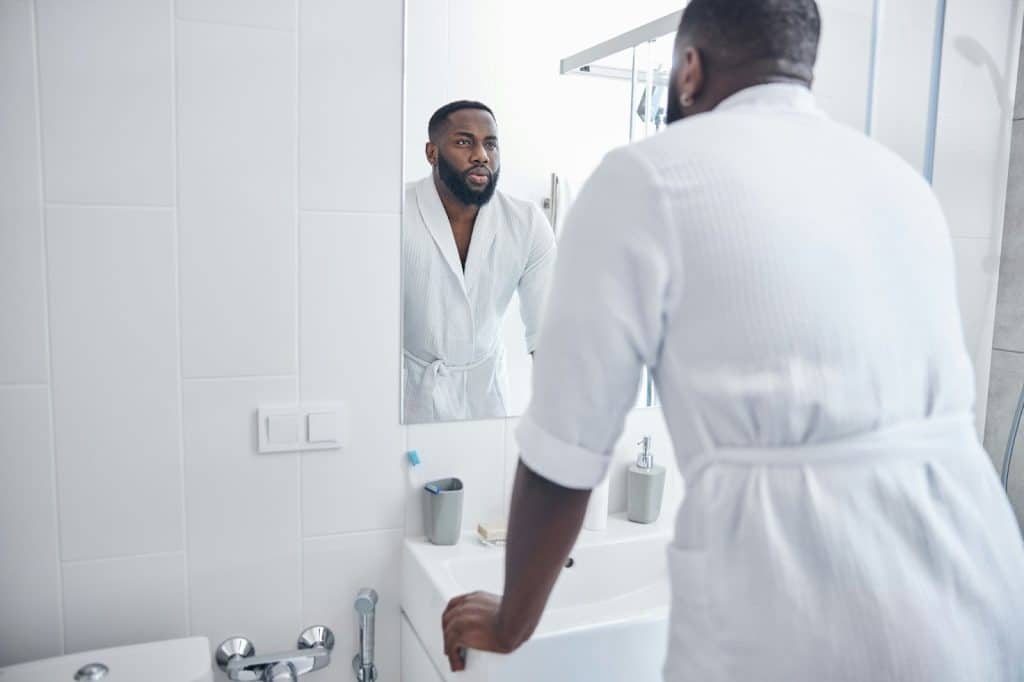 A man looking at the mirror