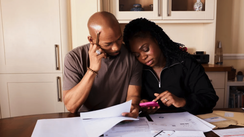 A couple calculating expenses.