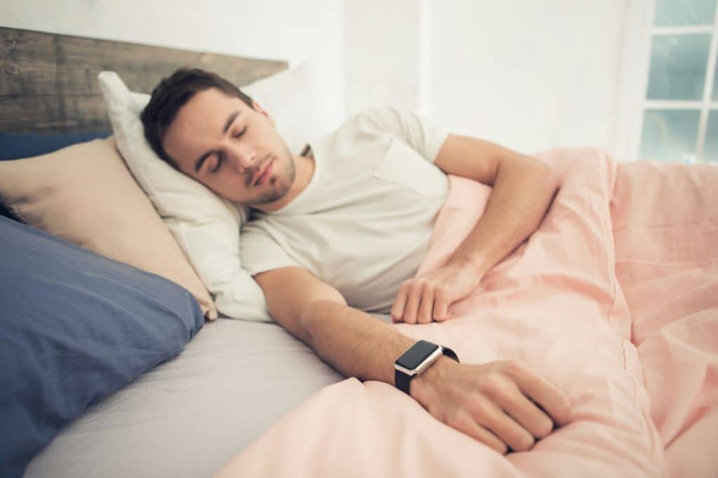 A man sleeping with a watch