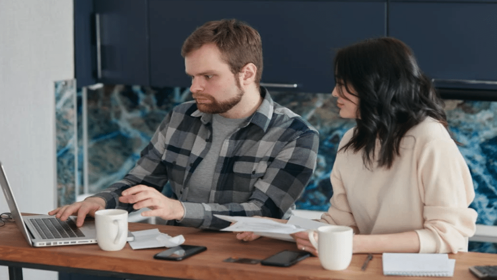 A couple working on something at home.