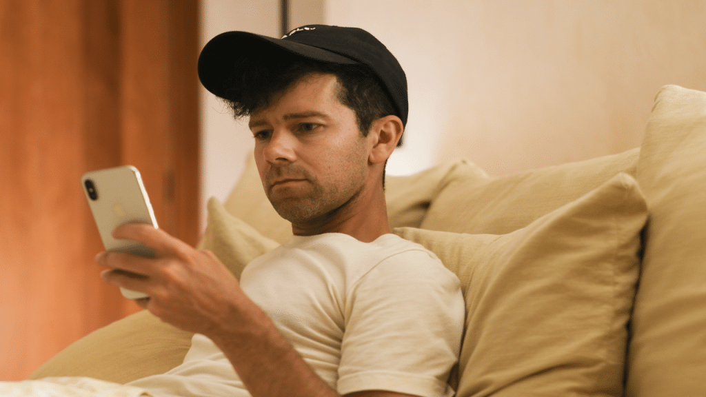 A man looking sad while texting