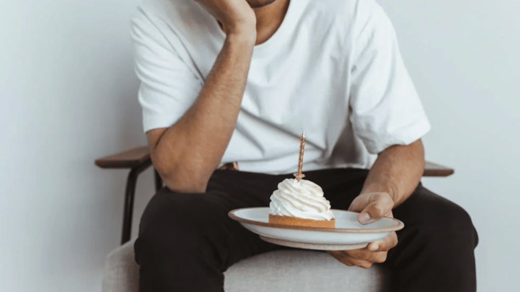 A man celebrating his birthday by himself.