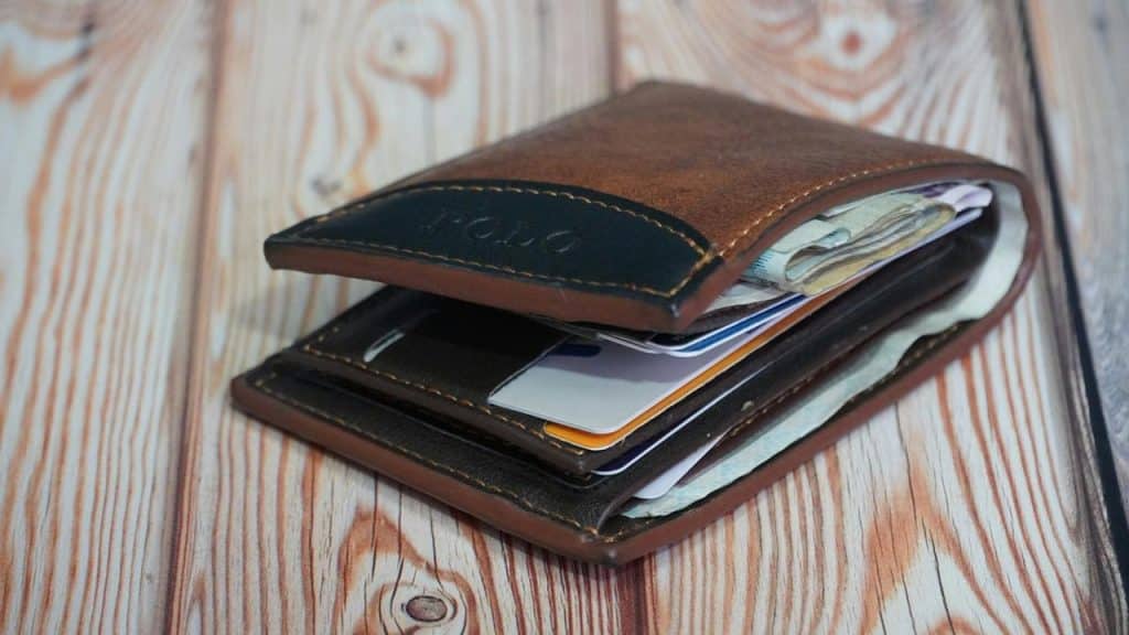 A full leather wallet with cash and cards inside.