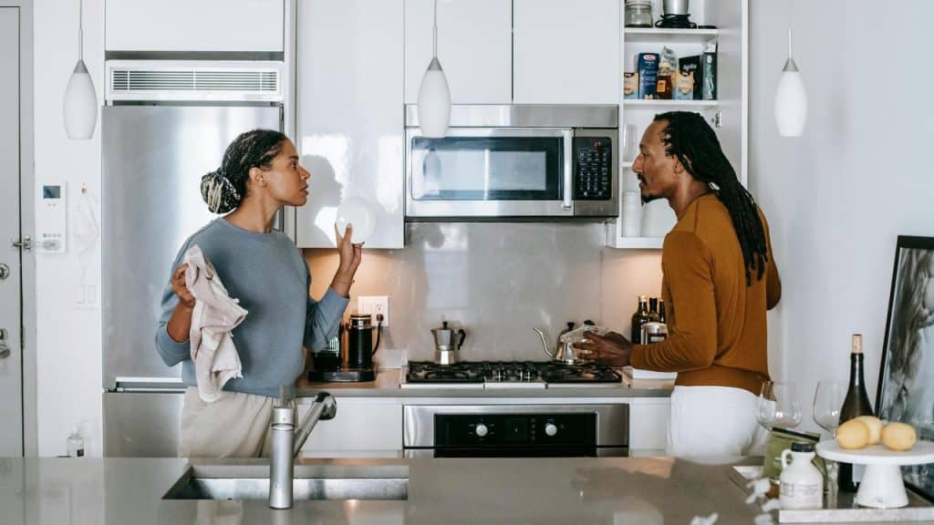 A couple arguing in the kitchen.