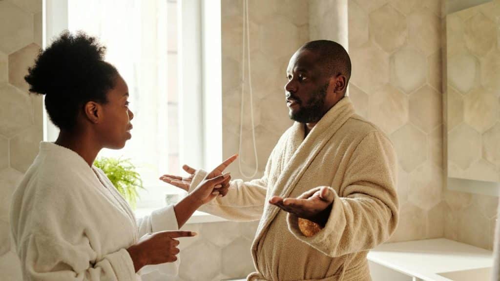 A couple arguing in a bathroom.