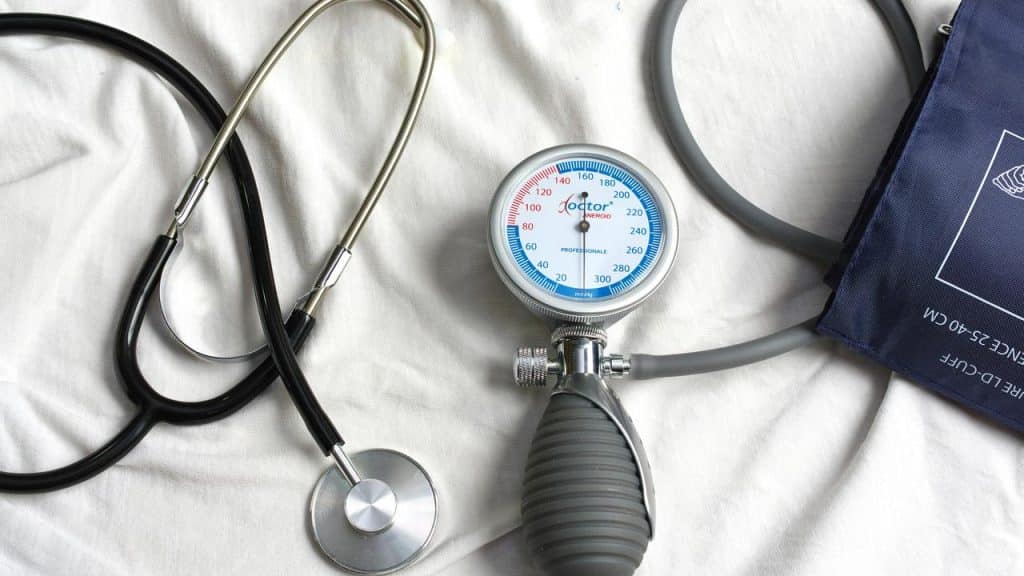 A stethoscope and blood pressure monitor on a white surface.