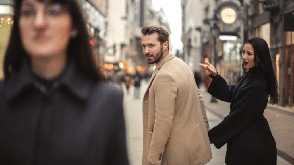 A man looking at another woman while with girlfriend.
