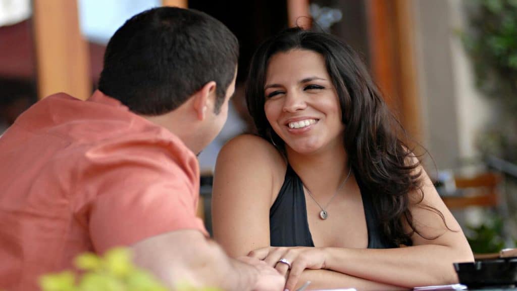 A couple conversing outdoors.