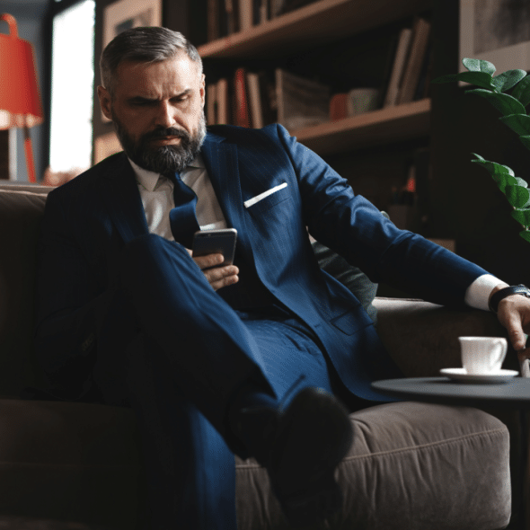 A man looking concerned while texting.