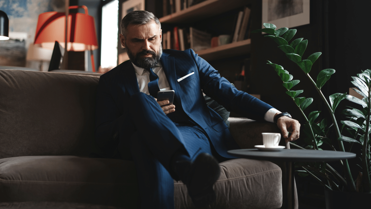 A man looking concerned while texting.