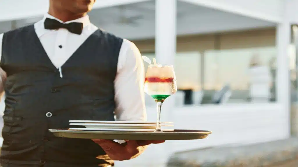 A waiter about to serve a drink