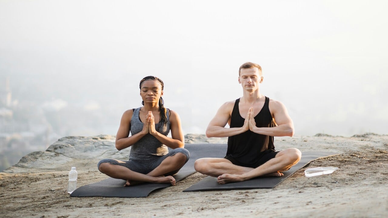 A couple doing yoga together.