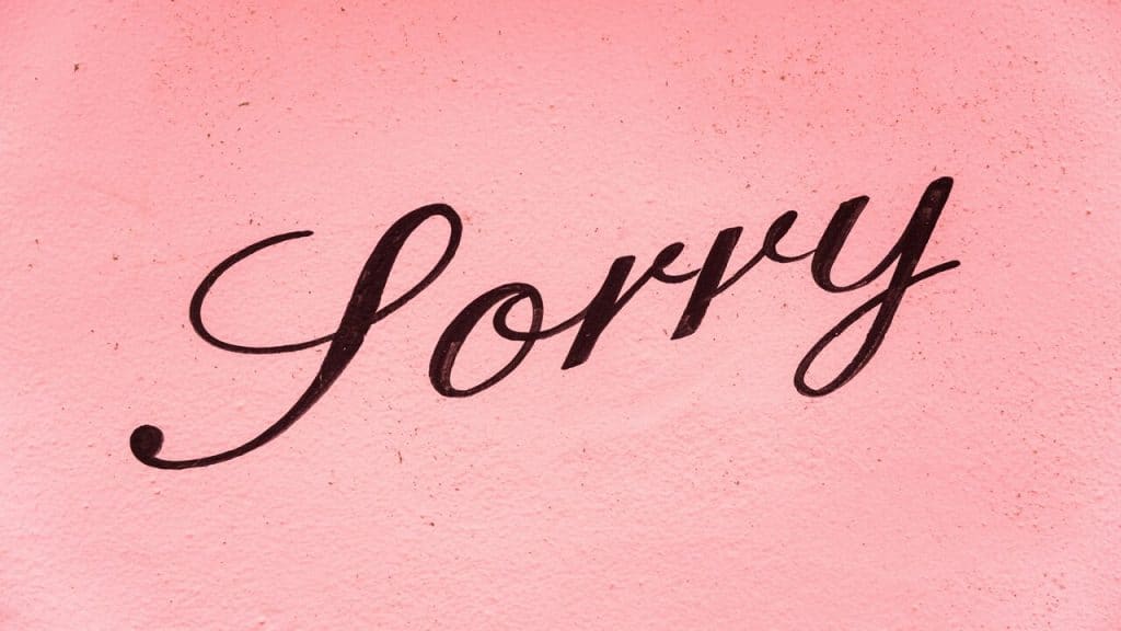 The word “sorry” written on a wall