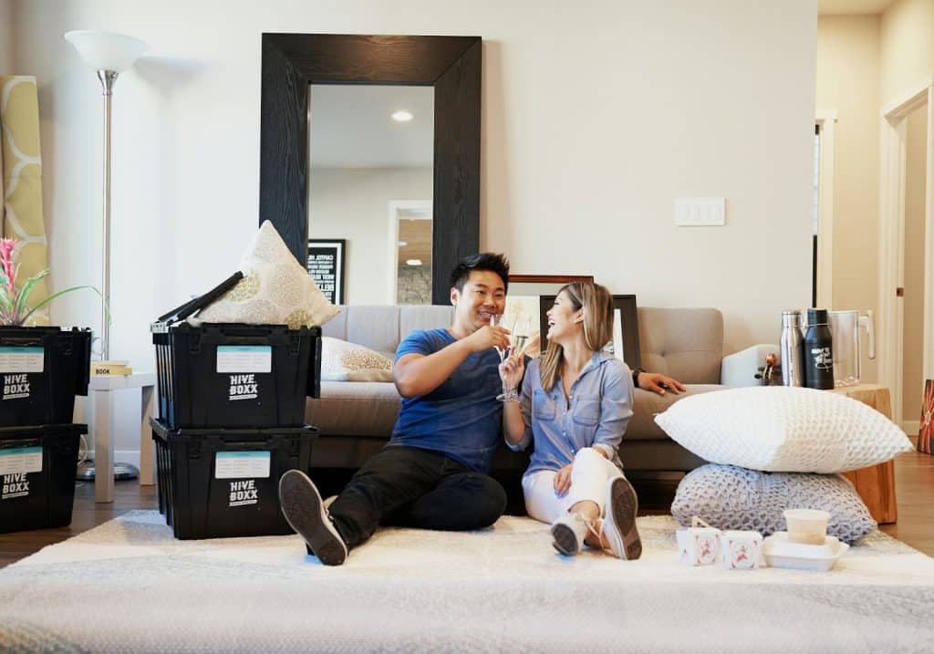 A man and woman sitting on the floor.