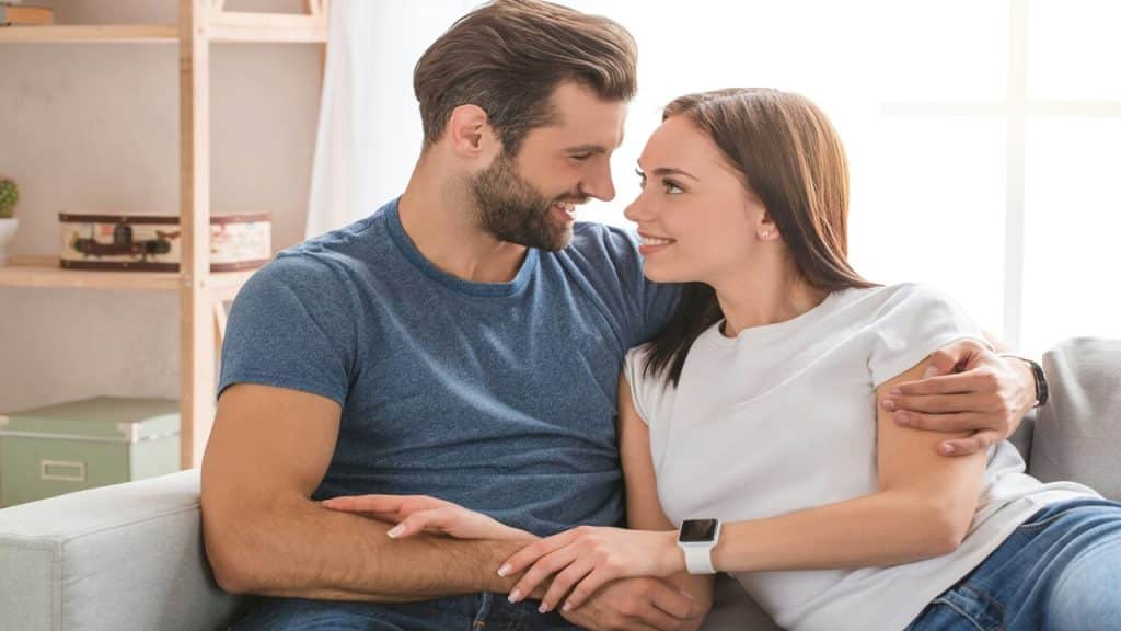 A couple looking at each other in the living room