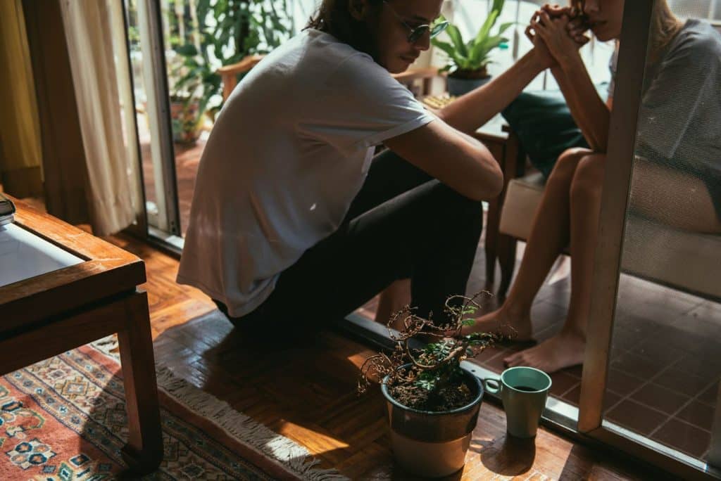 A woman holding the hand of a man.