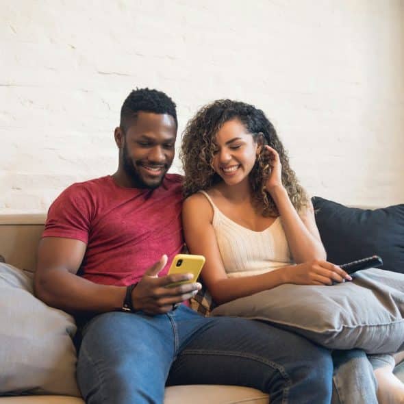 A man showing something to a woman.