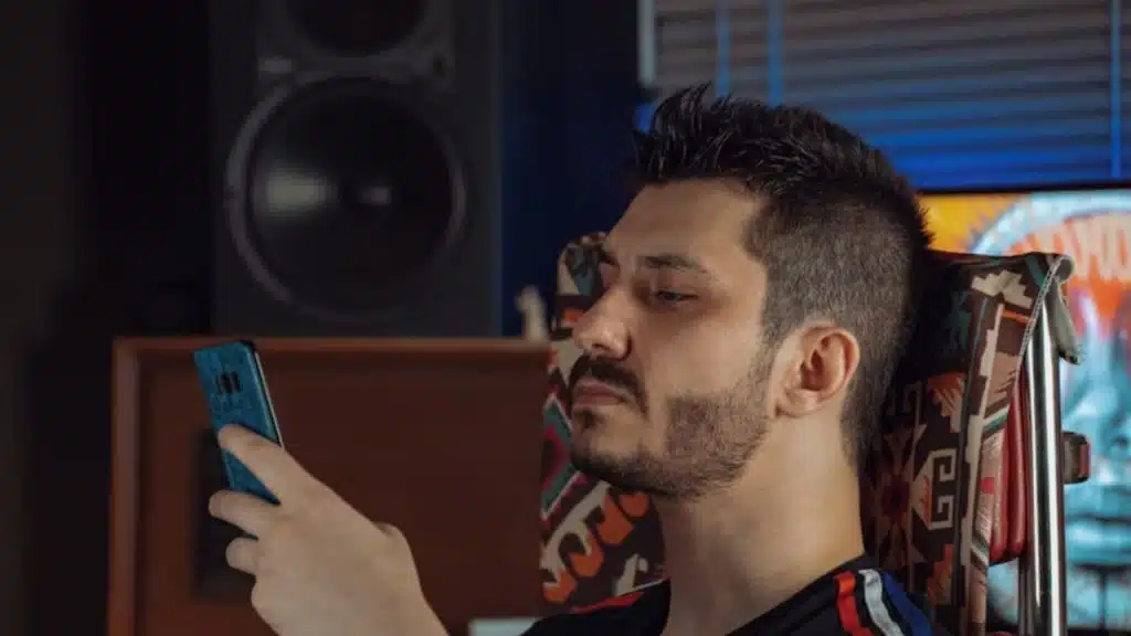 Man ignoring texts on purpose with a poker face