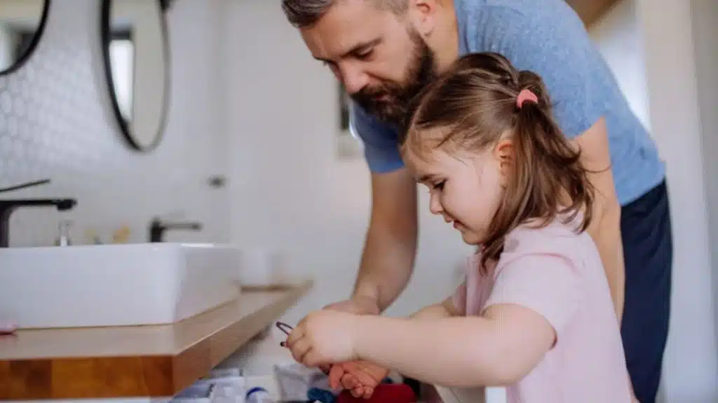 Man fixing a broken toy while kids watch