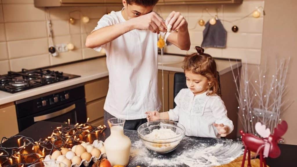 Dad and daughter baking together in the kitchen