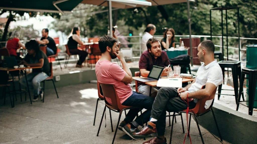 Group of men chatting casually at a coffee shop